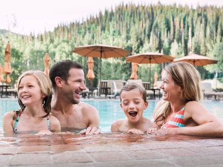 Family of four at the pool