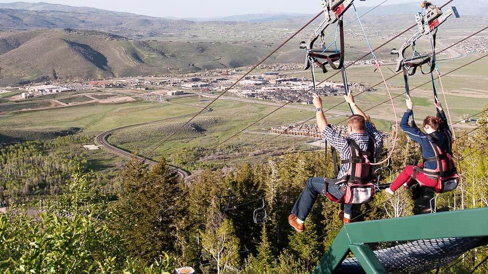 Two people zip lining